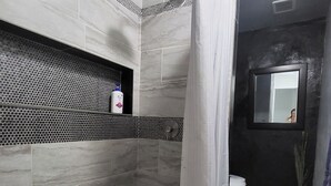 A modern bathroom with a shower, toilet, and a mirror. - 2 Story Cholla Bay Loft with Amazing Views and Private Beach Access Dog Friendly (Bahía la Choya)