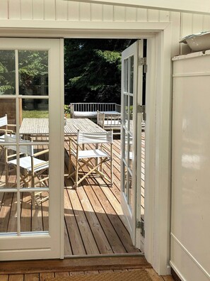 An open door leading to a wooden deck with outdoor furniture. - Forest house with private grounds in Liseleje (Frederiksværk)