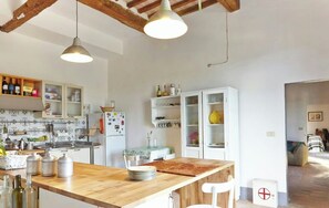 A kitchen with wooden countertops, white cabinets, and hanging pendant lights. - Rustic villa with pool in the heart of Chianti (San Casciano in Val di Pesa)