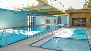 A swimming pool with multiple lanes, a changing room, and a wooden structure. - Maritime atmosphere in Holiday Island (Ebeltoft)