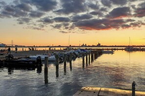 A marina with boats docked, a bridge in the background, and a sunset sky. - Family home near beach in Altefähr on Rügen (Altefähr)