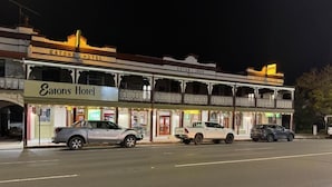 A hotel with a balcony on the second floor, a sign reading 'EATONS HOTEL,' and a vintage facade. - Eatons Hotel (Muswellbrook)