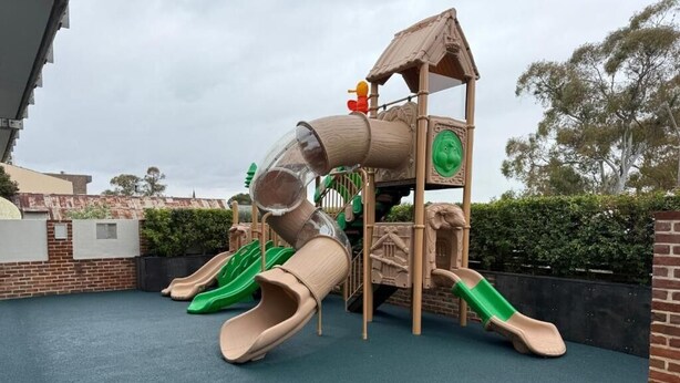 A playground with slides and a climbing structure. - Eatons Hotel (Muswellbrook)