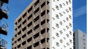 A multi-story building with a distinctive facade featuring a pattern of stars and a contrasting white section. - Olfea Namba South No.11 (Osaka)