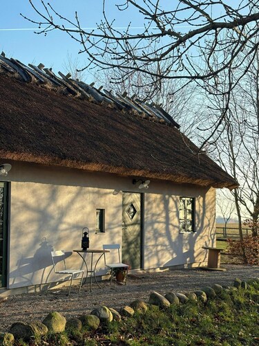Stone house with thatched roof on 1750s farm