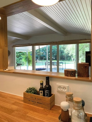 A kitchen with a wooden countertop, a window with a view of a deck, and a wooden crate labeled 'Local & Fresh The Green Market'. - Renovated holiday home near Als Odde Beach (Hadsund)
