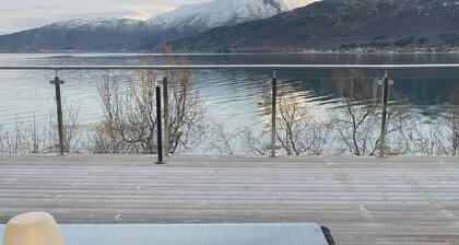 Seafront retreat with panoramic mountain views