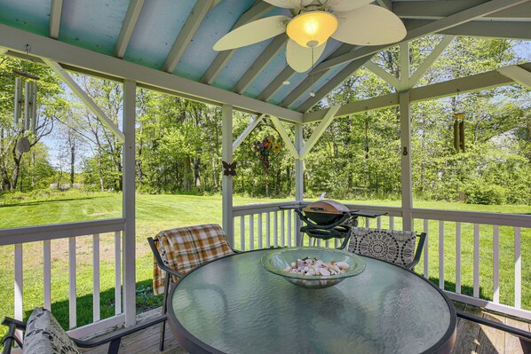 A covered outdoor seating area with a table, chairs, and a grill. - Trailside Base w/ Gazebo & Kayaks (Stormville)