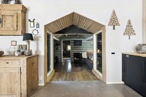 A wooden interior with a kitchen area, a dining space, and a living room with a sofa and table. - Historic cabin idyll by Espedalsvannet (Espedalen)