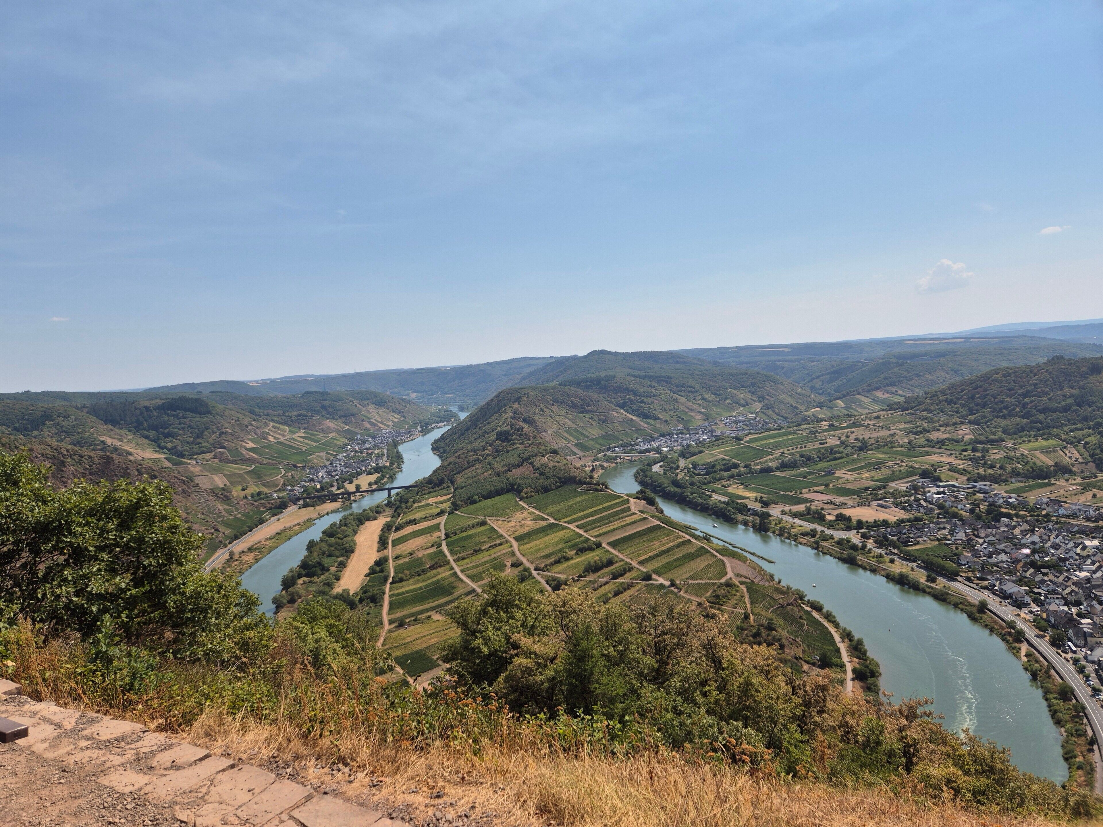 A river valley with terraced fields and a small settlement.