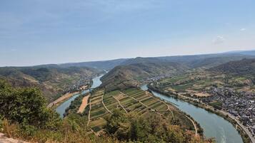 A river valley with terraced fields and a small settlement.
