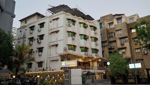 A multi-story building with a sign for 'treebo' on the ground floor, air conditioning units, and a gated entrance. - Treebo Vice President (Ahmedabad)