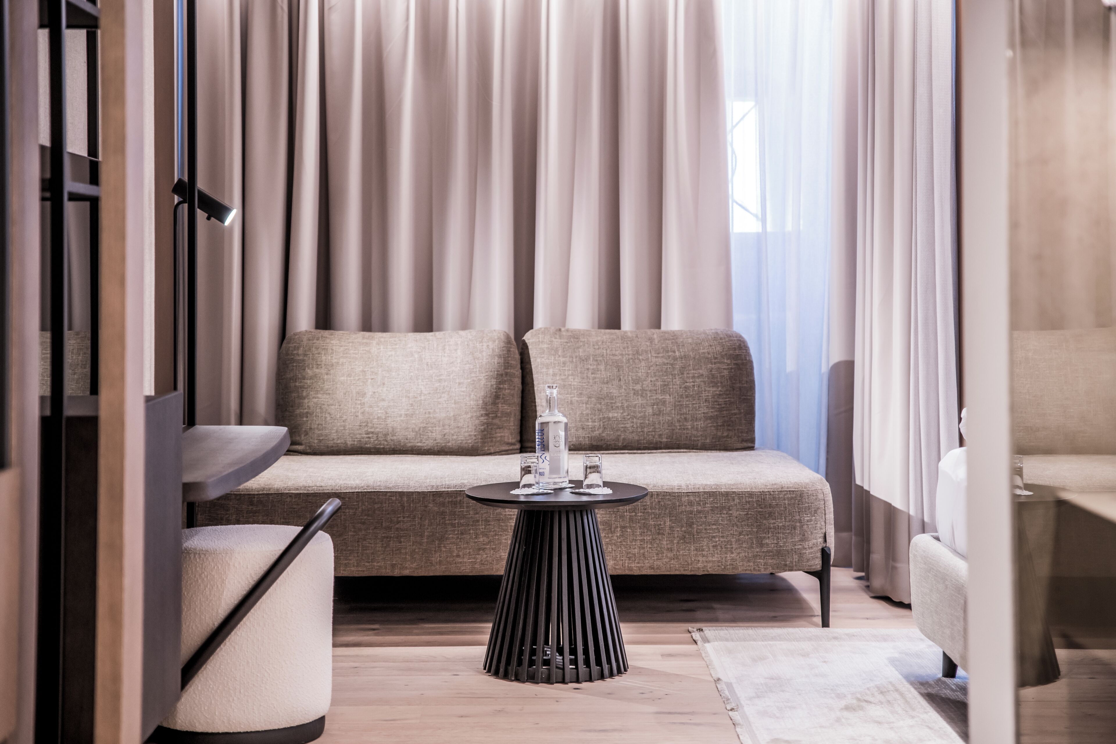 A modern living room with a sofa, a round table, and a coffee table.