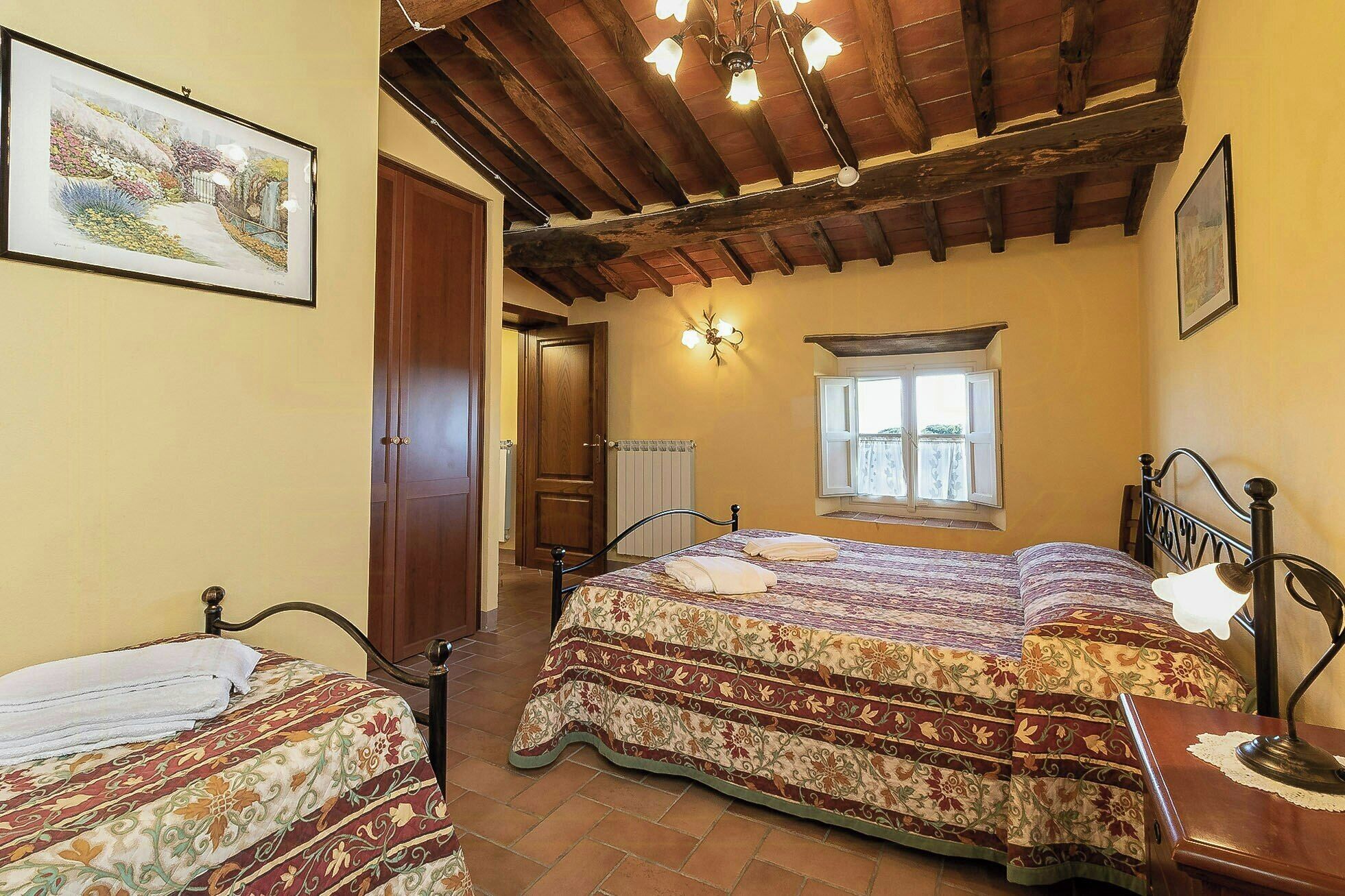 Una camera da letto con un letto, una sedia, una scrivania, una finestra e una porta.