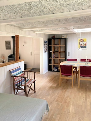 A dining area with a wooden table, chairs, and a bookshelf.
