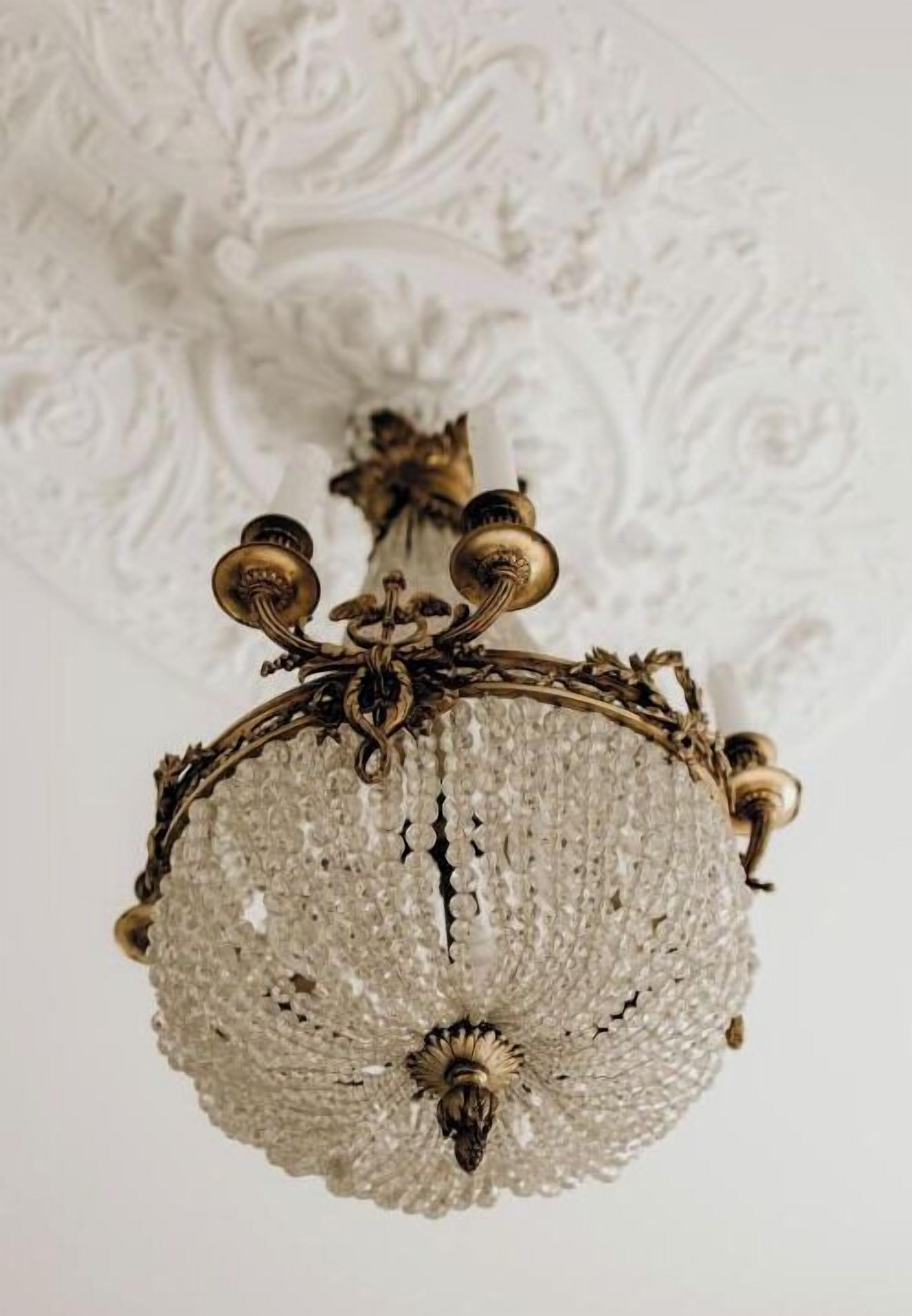 A chandelier with a textured, crystal-like design and ornate metalwork.