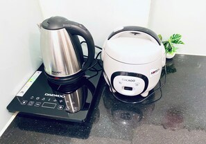 A Daewoo coffee maker and a Cuckoo rice cooker on a kitchen counter. - Apartment near Tan Son Nhat Airport (Tan Son Hoa)