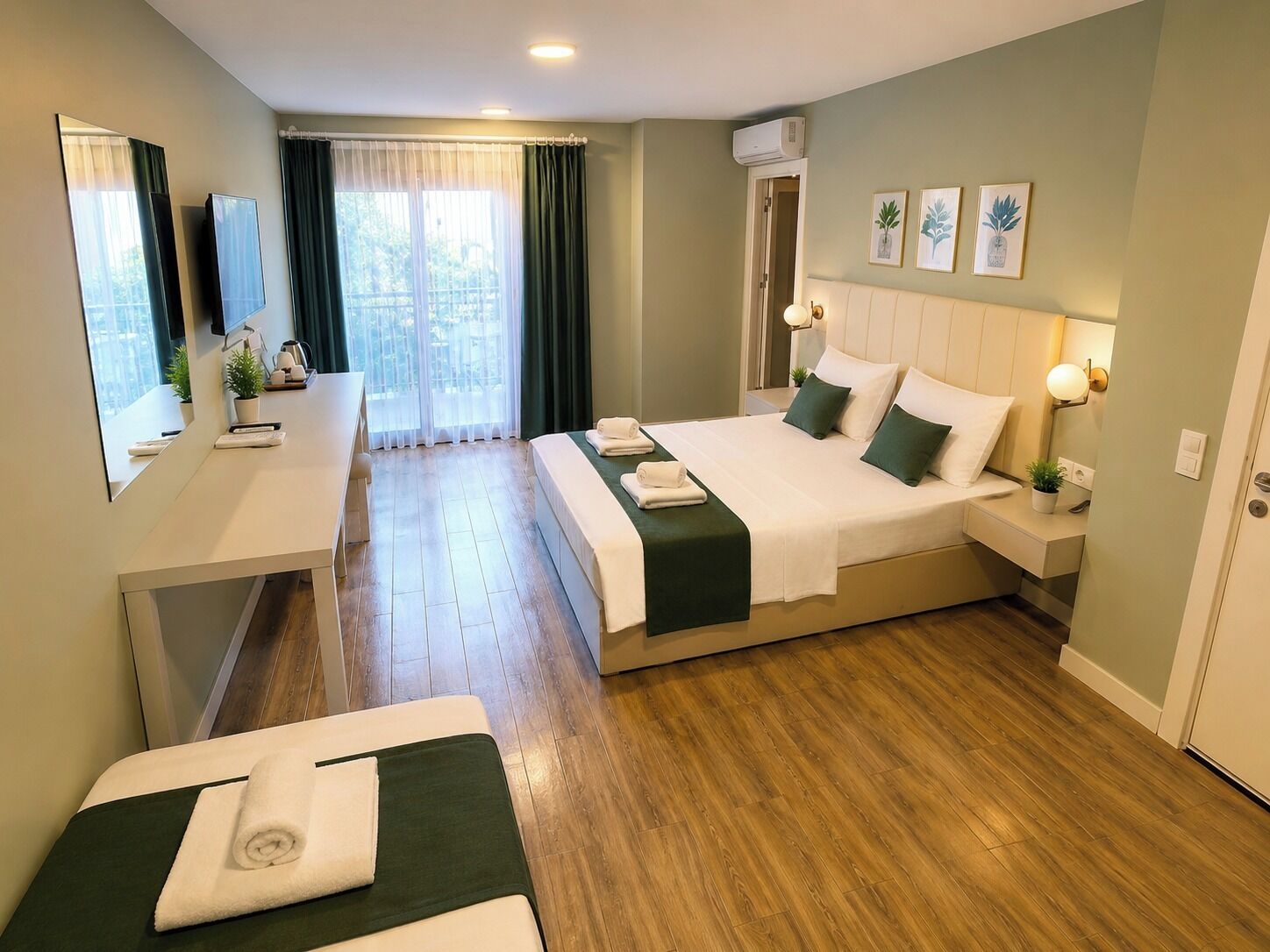 A hotel room with a bed, a desk, a chair, a mirror, and a window with curtains.