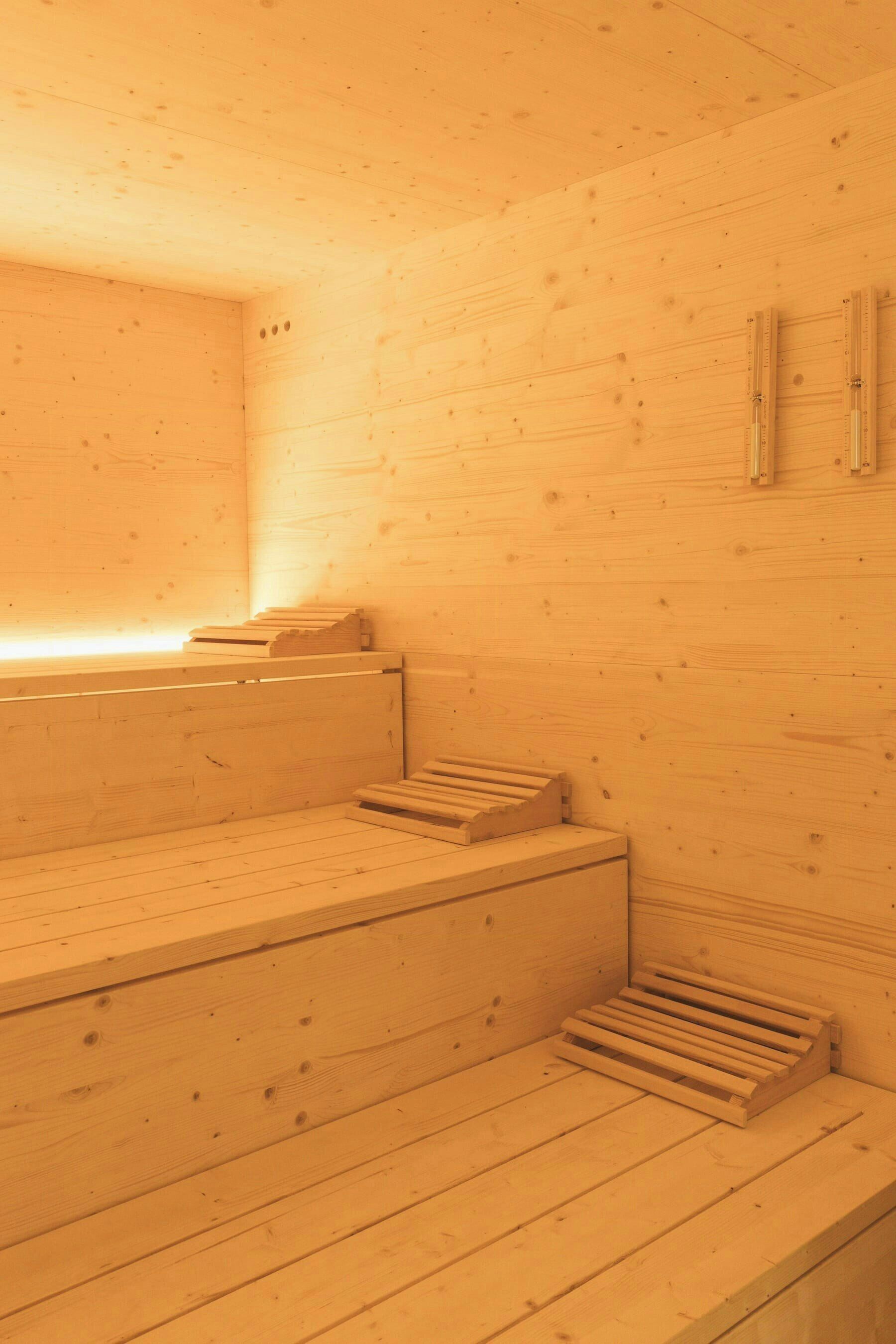 A wooden sauna with benches and a bench seat.