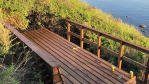 A wooden deck with a railing overlooking a body of water. - "Lærkehuset" right by Kalundborg Fjord (Kalundborg)