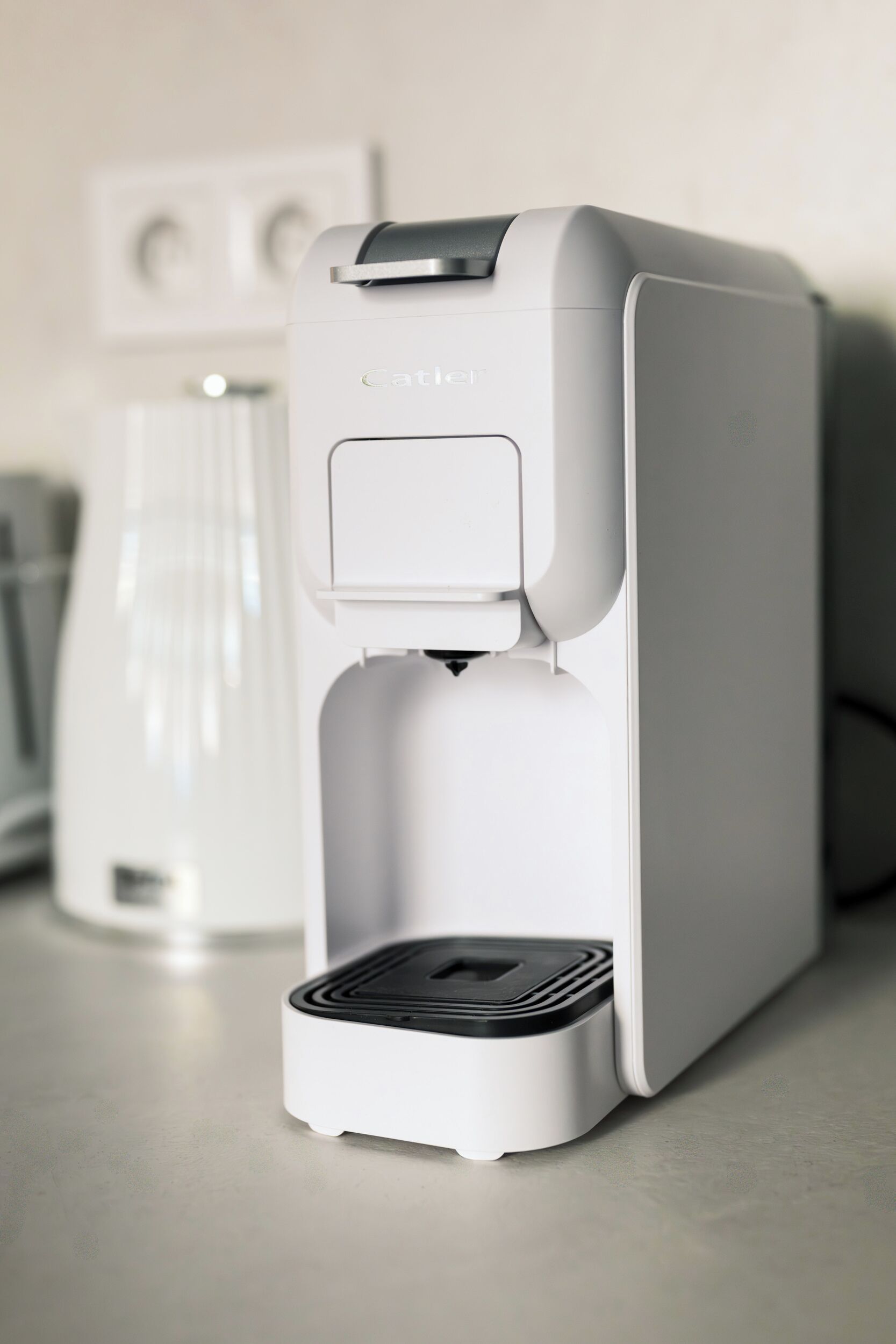 A white coffee machine with a control panel and a water reservoir.