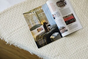 A magazine page with a travel article, a dog, and a suitcase. - Designer attic studio with smart TV and WiFi (Hlavní město Praha)