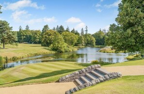A golf course with a pond, stone steps, and a clear sky. - 28 Guthrie Court - Gleneagles Village (Gleneagles Village)