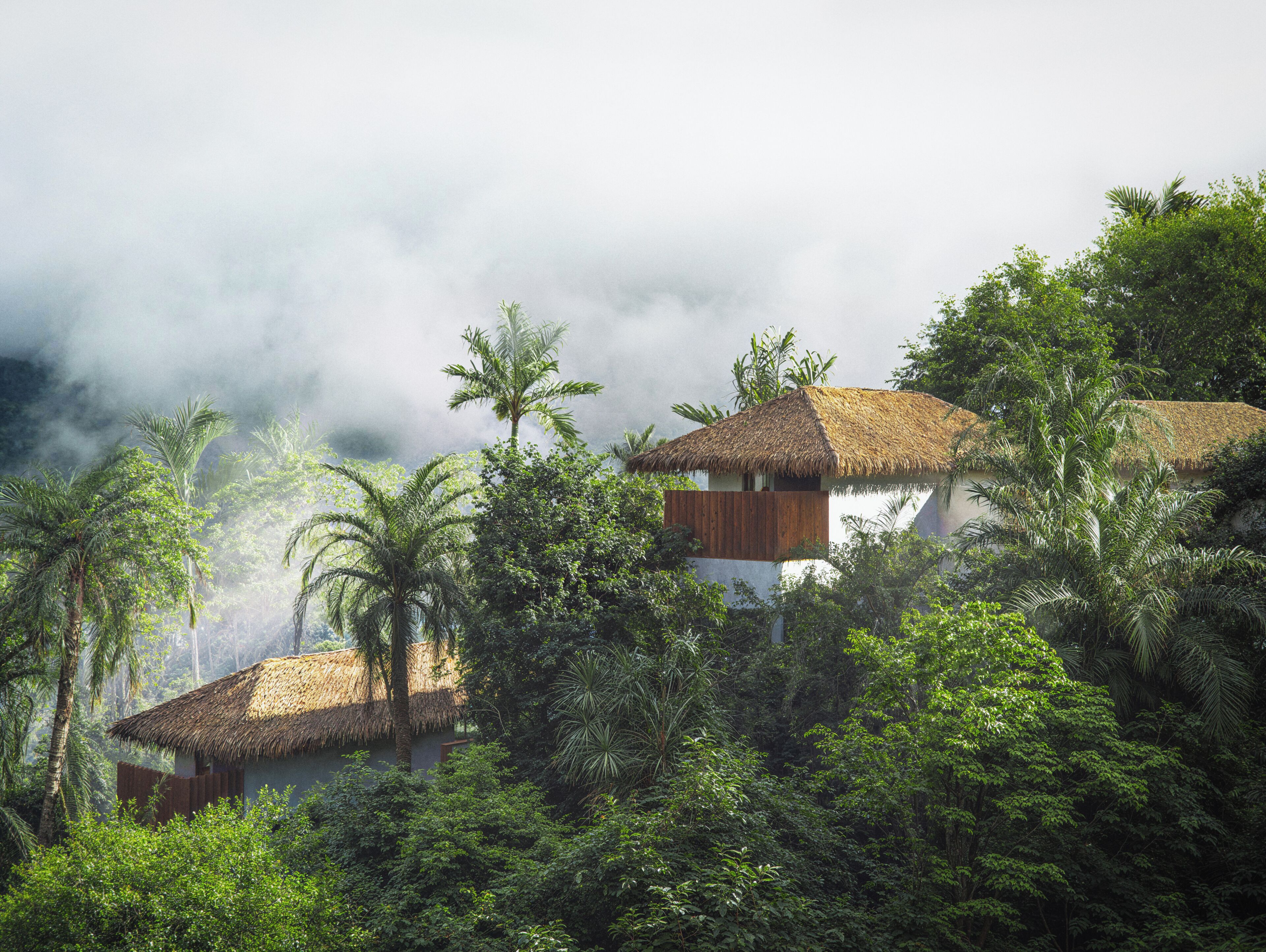 A thatched-roof building surrounded by lush greenery and clouds.