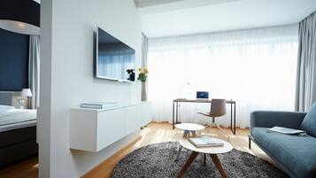 Deluxe Apartment | Living area | 55-inch flat-screen TV with cable channels, offices