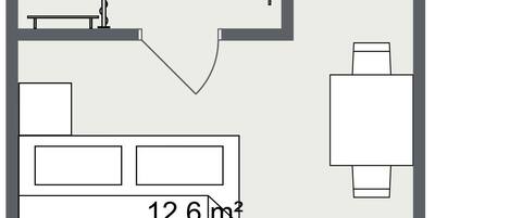 Un plano de planta que muestra una cocina, un comedor y una sala de estar.