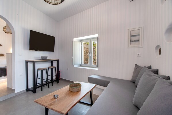 Living area - Naexon Vivlos Stone Escape Apartment with Shared Rooftop, Wi-Fi, and Air Conditioning (Βίβλος)