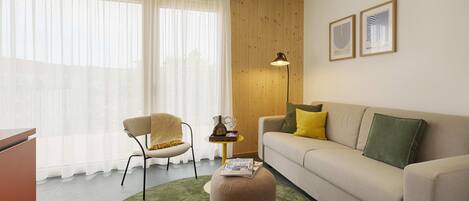 A living room with a sofa, ottoman, chair, and a lamp.