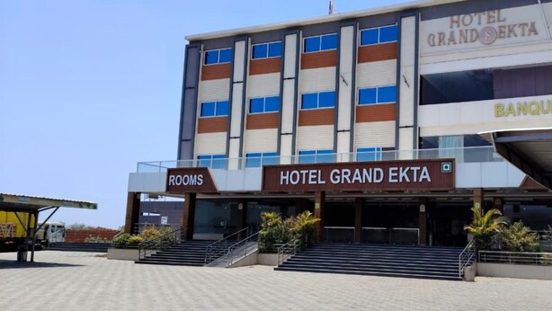 A hotel with a sign for 'Hotel Grand Ekta' and a 'Banquet' section.