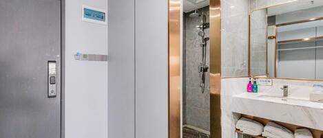 A modern bathroom with a shower, a sink, and a mirror.