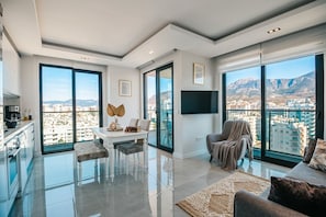 Luxury Apartment, Balcony, Sea View | Living area | 100-inch Smart TV with cable channels, Netflix, DVD player