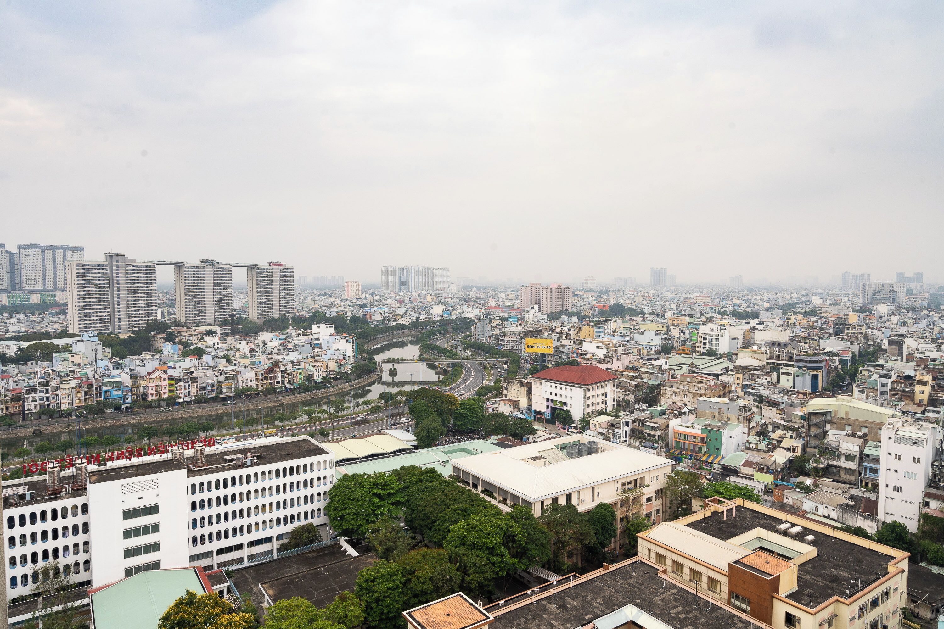 A cityscape with high-rise buildings, a river, and a mix of residential and commercial structures.