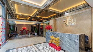 A hotel reception area with a marble counter, a 'Welcome Home' sign, and a modern interior design. - Imperial Suites by Kieu by Kita (Ho Chi Minh City)
