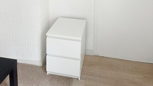 A white wardrobe with a wooden hanger rack above it. - Charming Studio Steps from City Center (Ghent)