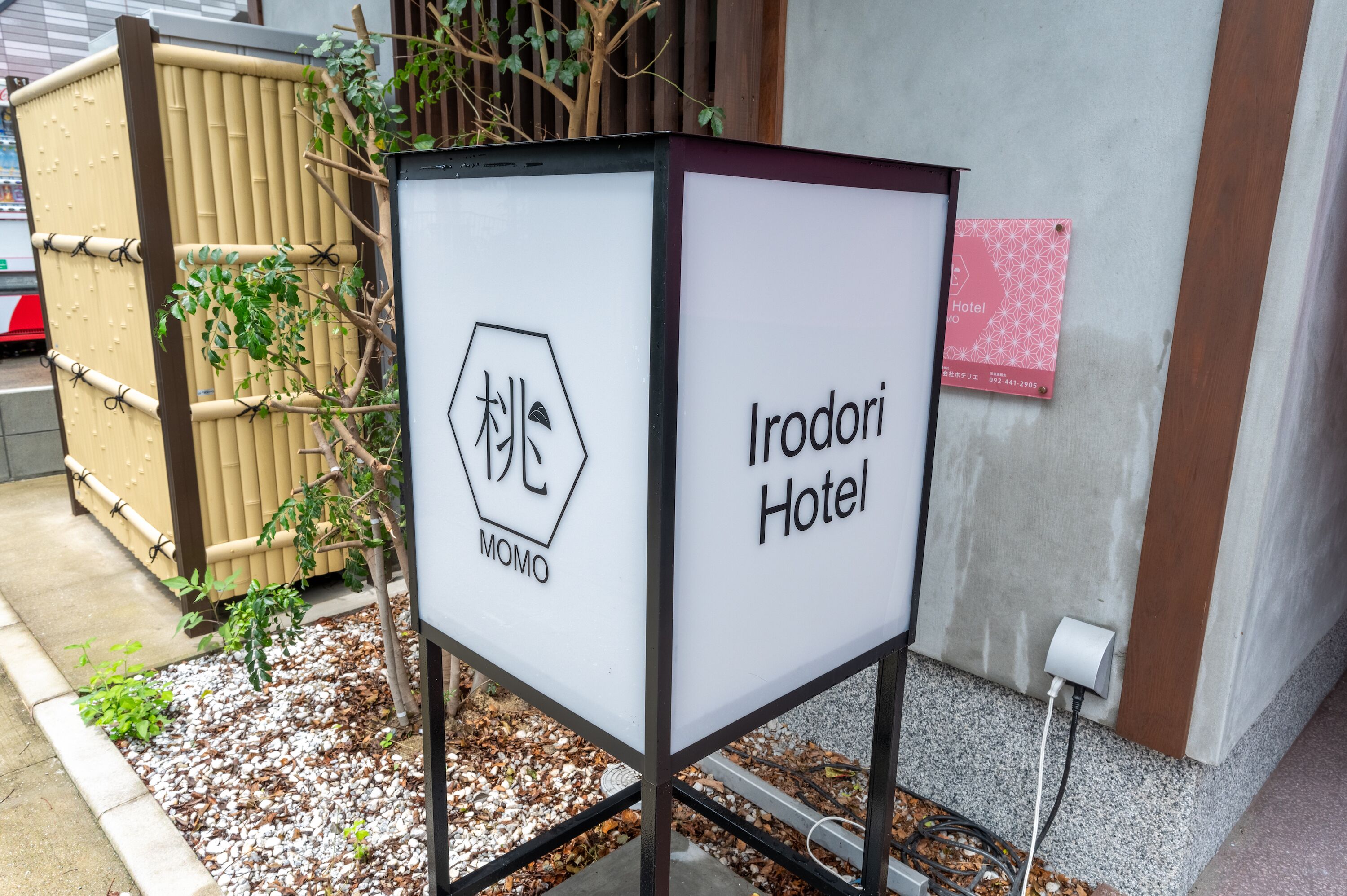 A sign for Irodori Hotel with a logo and name.
