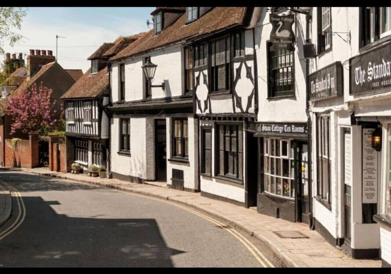 A traditional building with a pub named 'The Swan Cottage' and another establishment called 'The Standard Inn.'