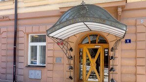 A hotel entrance with a marquee sign, a large wooden door, and a number '8' on the wall. - Lovely studio in the center city (Hlavní město Praha)