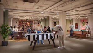 A modern indoor space with a foosball table, a pool table, and a billiards table. - ARK Shoreditch (London)