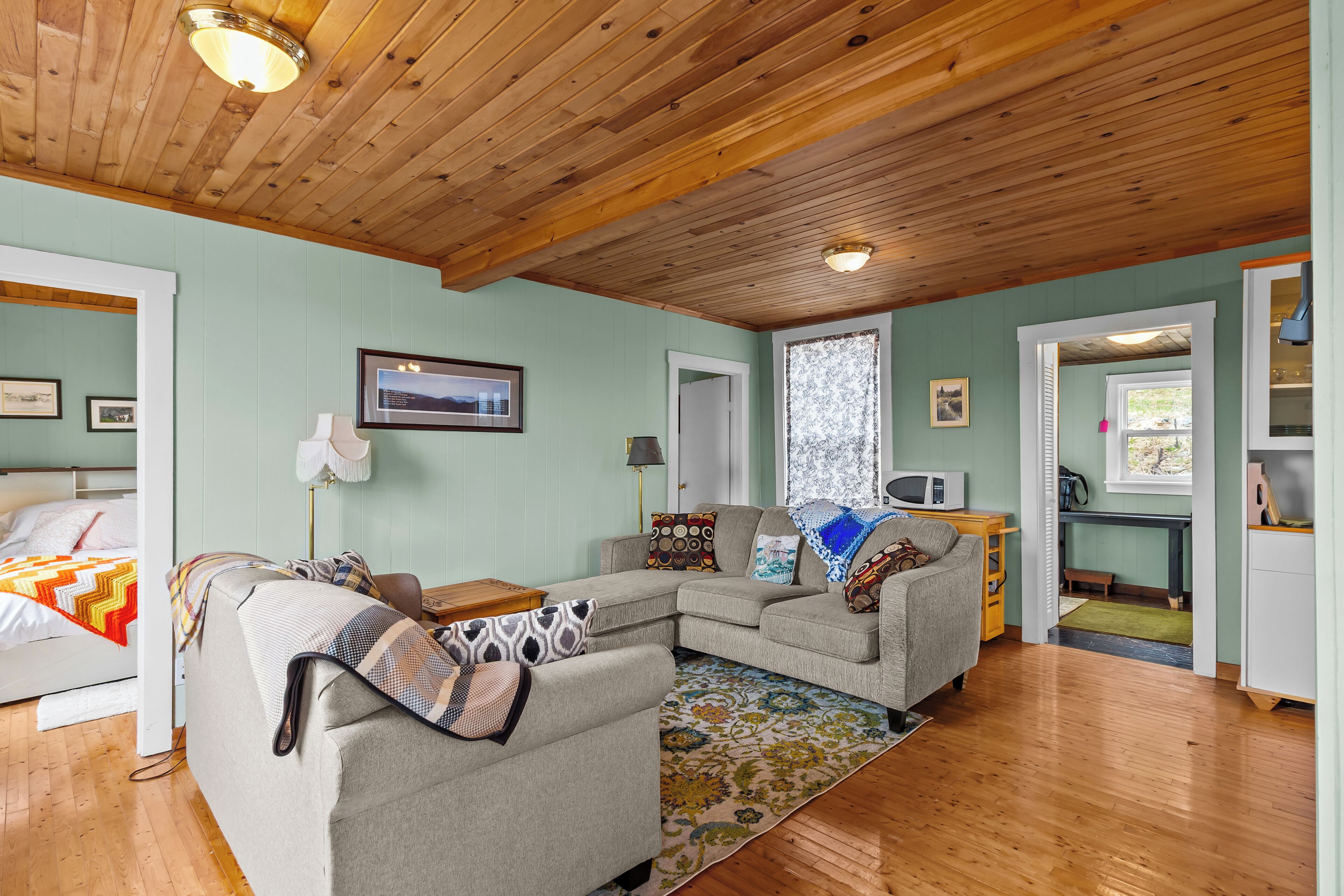 Bright cozy living room with wood ceiling and natural light