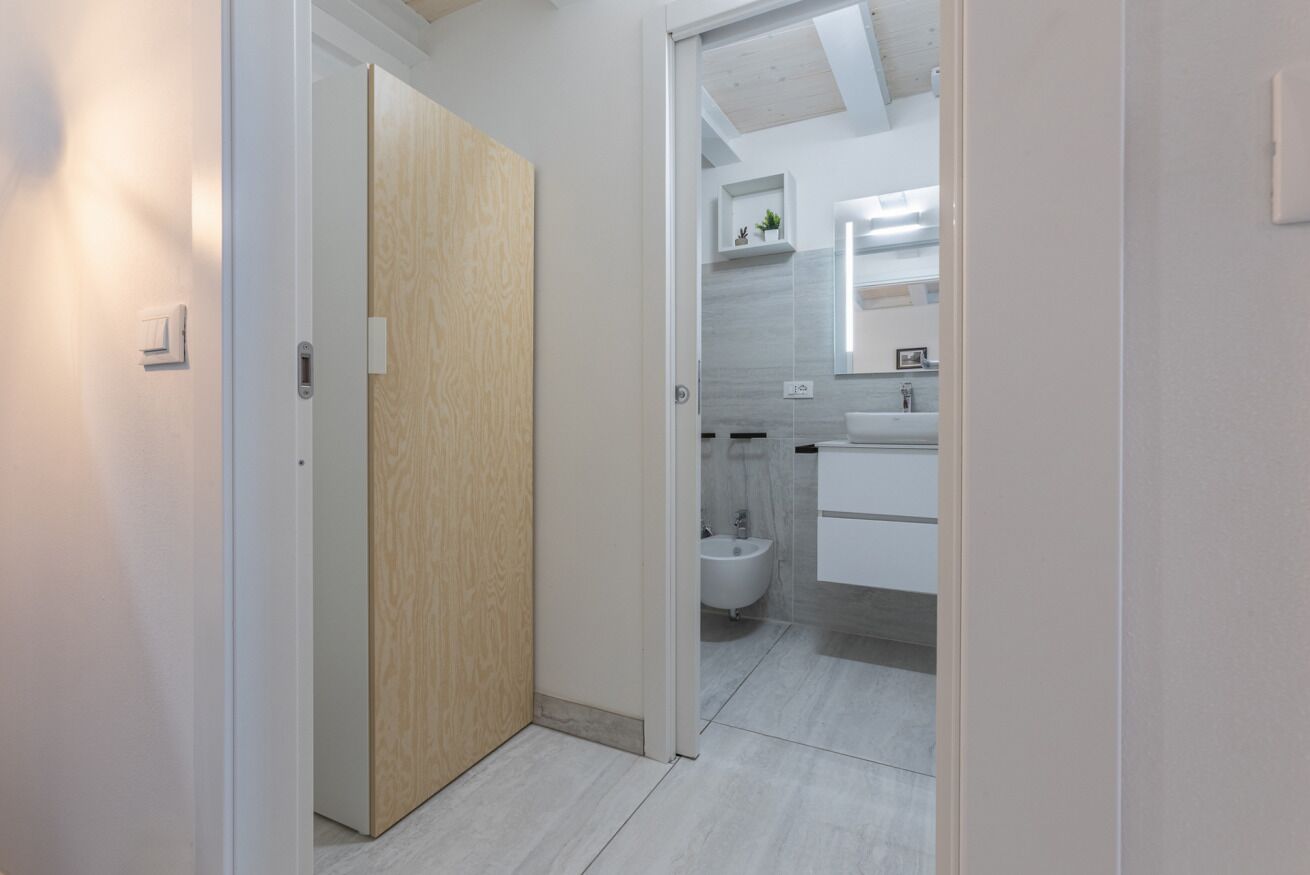 A modern bathroom with a toilet, bidet, and a sink.