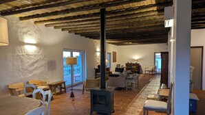 Un intérieur rustique avec une cheminée en pierre, des meubles en bois et un coin repas.
