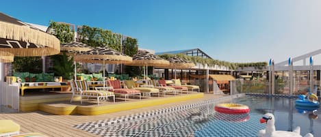 A poolside area with lounge chairs, umbrellas, and a swan float.