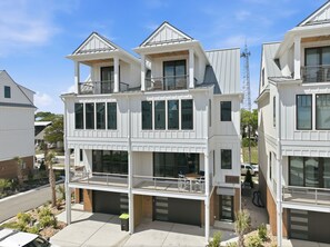 A multi-story residential building with a balcony, large windows, and a garage. - Just Baskin- Walking Distance-Downtown Morehead City (Morehead City)