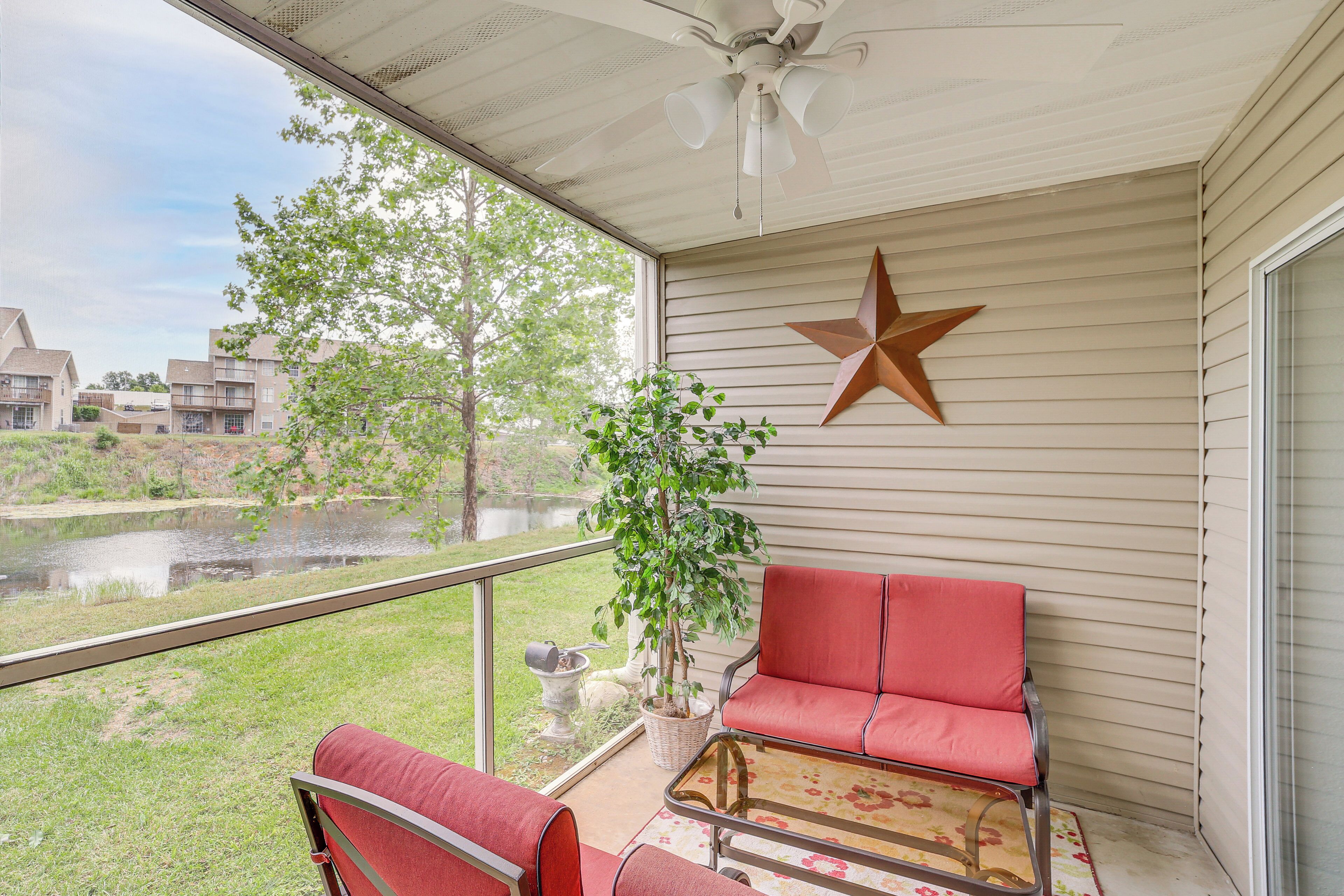 A covered balcony with a red chair, a star decoration, and a potted plant.