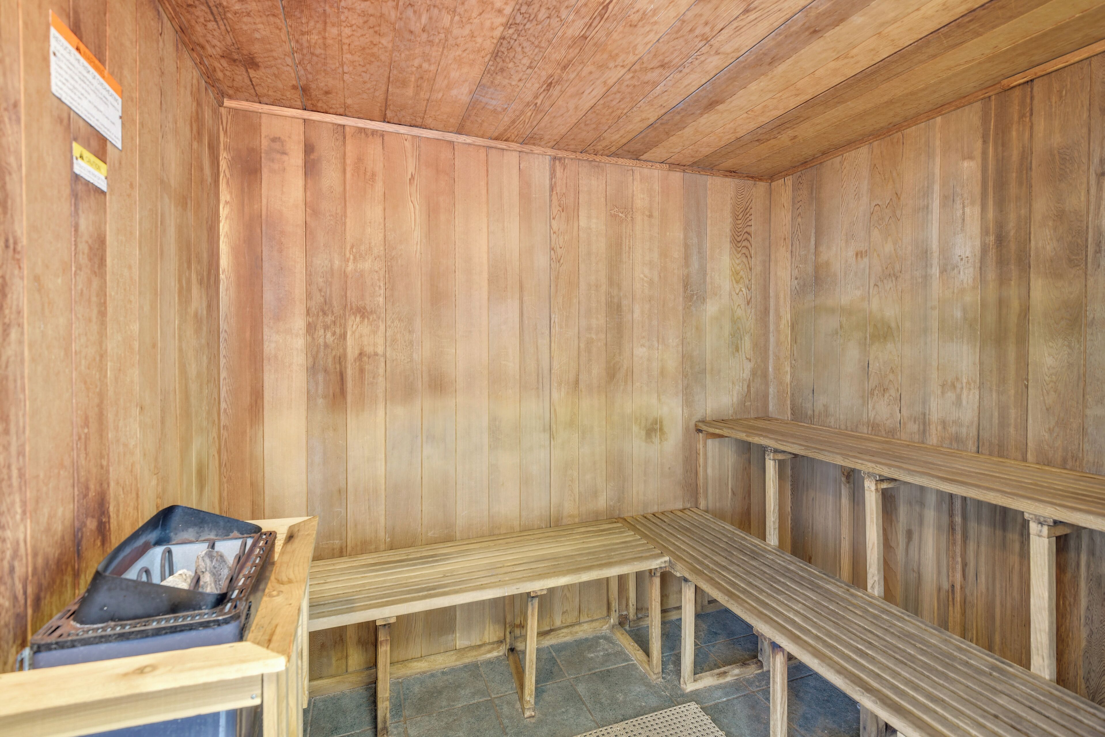 A sauna room with wooden walls and benches.