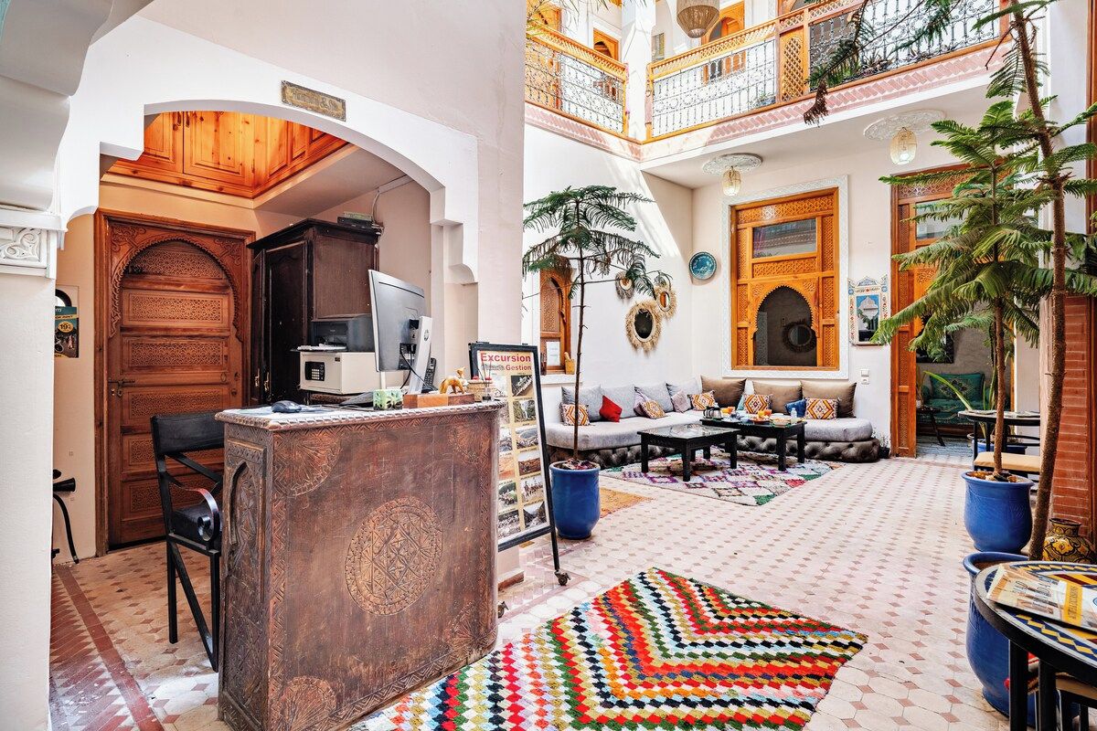 A spacious living area with a sofa, coffee table, and a patterned rug.